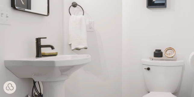 Greater Lansing basement bathroom remodeling project built by Custom Built Design and Remodeling with porcelain sink and towel ring
