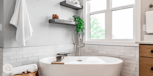 luxury bathroom remodeling project in Greater Lansing built by Custom Built Design and Remodeling with freestanding bathtub and floating shelves