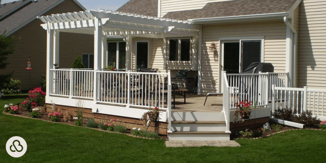 outdoor living project in Greater Lansing with composite deck and white pergola