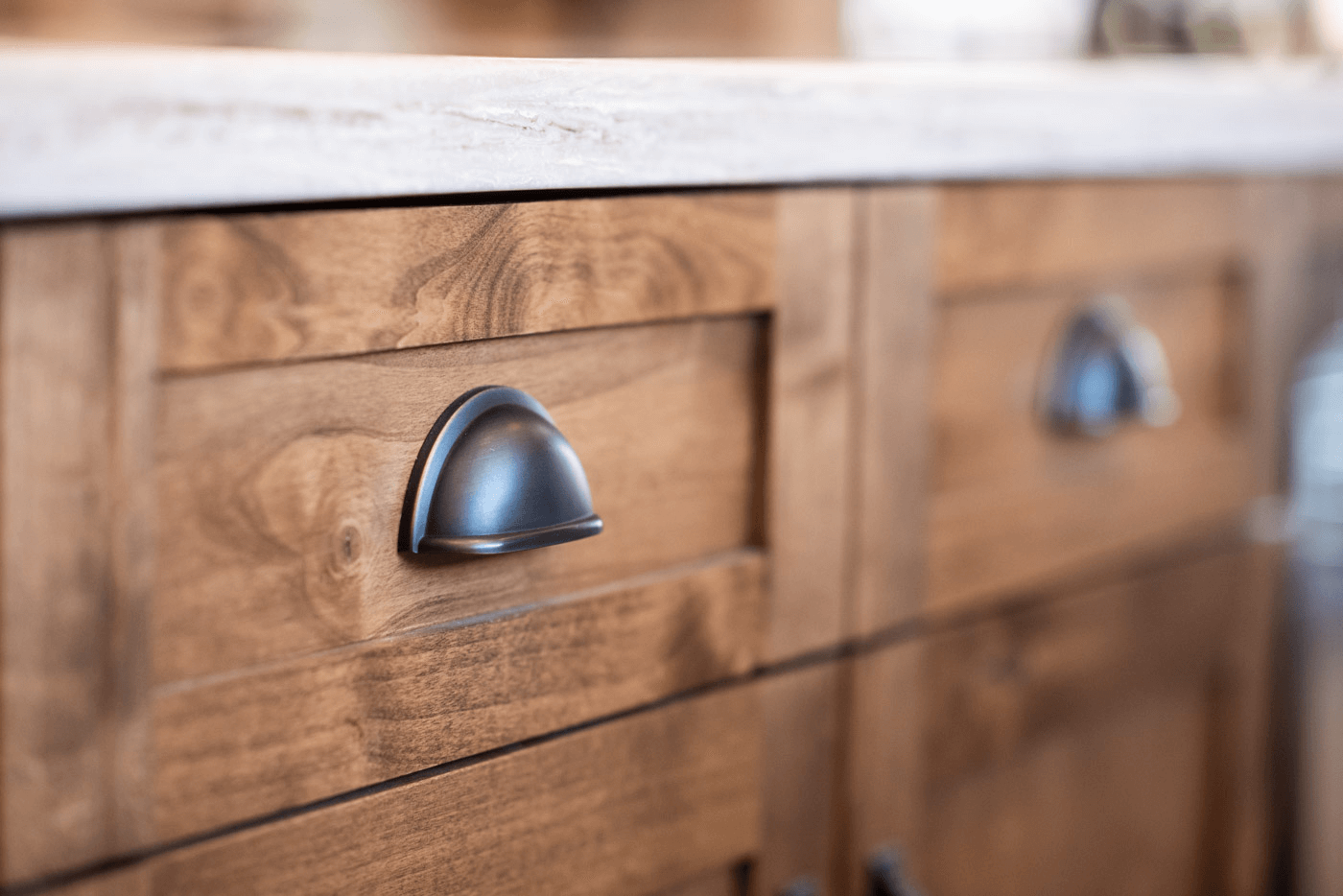 Antique cabinet hardware on a wood faced cabinet
