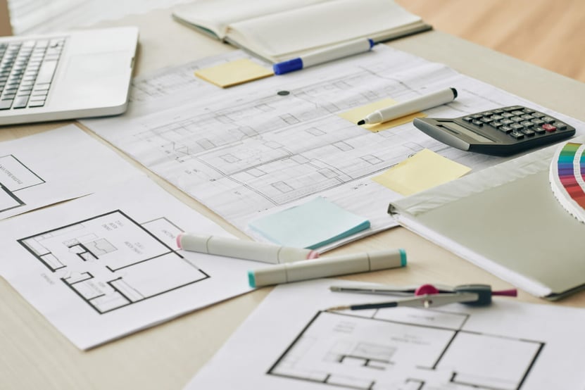 Construction plans, pencils, calculators, and markers