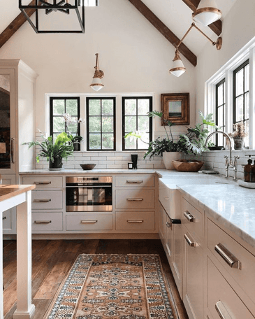 Remodeled kitchen with white cabinets and mixed metals