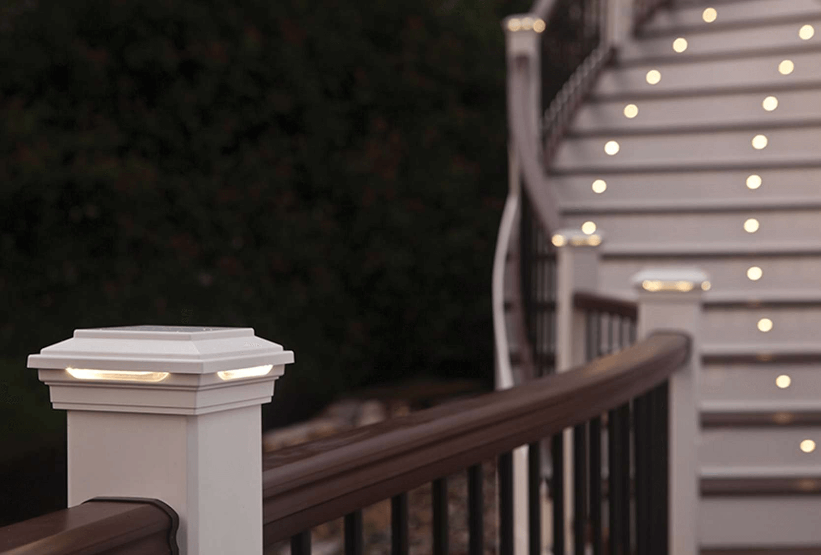 Outdoor deck with post cap and stair riser lights