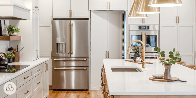 kitchen remodeling project in Greater Lansing built by Custom Built Design and Remodeling with quartz island and modern refrigerator