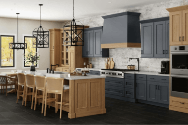 Kitchen with dark blue cabinets, stone backsplash, and white countertops