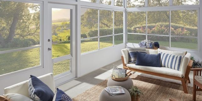 Greater Lansing patio enclosure sunroom addition with luxury furniture and white windows