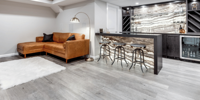 basement flooring reviews carpet luxury vinyl plank and epoxy compared gray floor with wet bar area custom built michigan