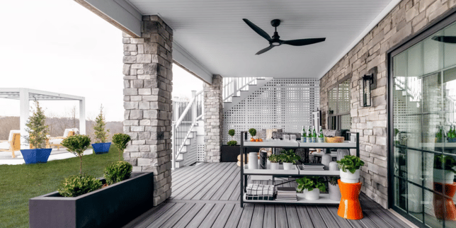 comparing decking materials for your michigan outdoor living space under deck lounge area custom built okemos