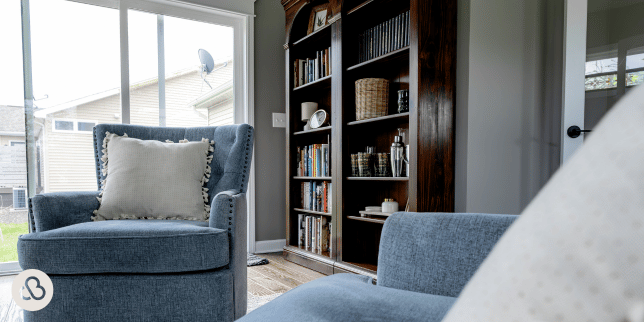 top home addition contractors in lansing michigan sunroom with armchairs and wooden bookcase custom built mi