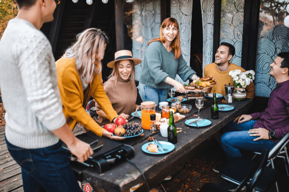top ways to design your deck for hosting friends and family enjoying dinner party outdoor living space custom built michigan