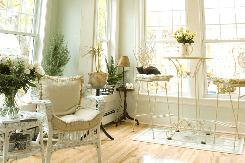 top interior design strategies for your sunroom addition chair and house plants near window custom built michigan