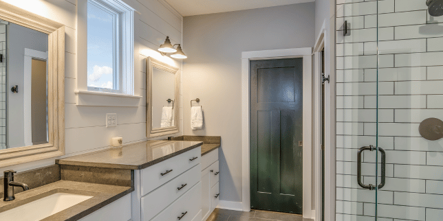 questions to ask yourself before starting a bathroom remodel large vanity space with glass shower door custom built michigan