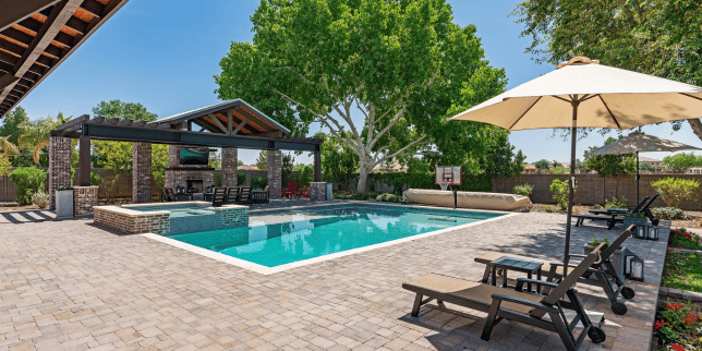 the complete guide to pool decks stamped concrete deck with pergola and lounge chairs custom built michigan