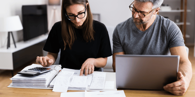 mistakes to avoid while financing your home remodel couple budgeting at laptop custom built michigan