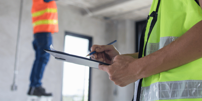 how inspection affect your home remodeling project timeline inspector holding clipboard custom built michigan