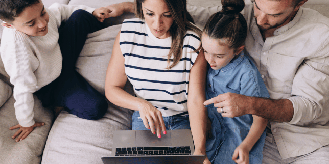 home remodeling problems families face during planning family looking at laptop on couch custom built michigan