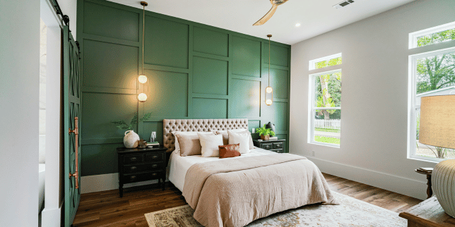 how to design a primary suite addition that feels like a retreat modern bedroom with green accent wall custom built michigan
