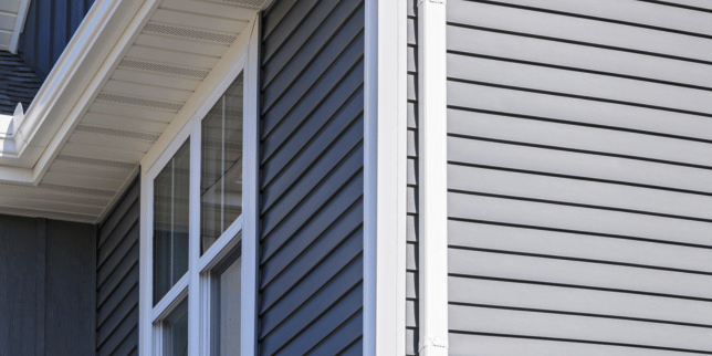 signs its time for a siding replacement vinyl boards on home exterior with downspout gutter custom built michigan