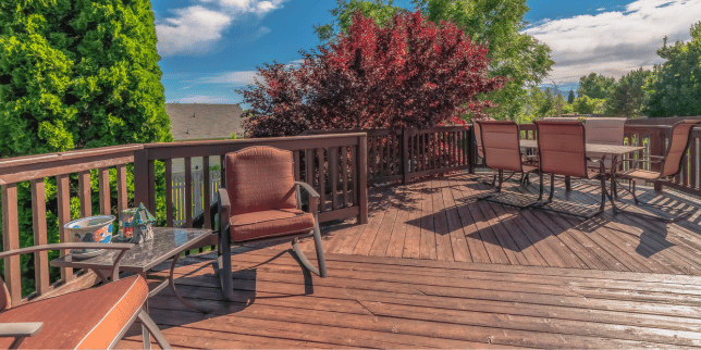 Lansing cedar deck outdoor living space with furniture and trees