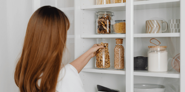 homeowner in Greater Lansing storing goods in kitchen pantry