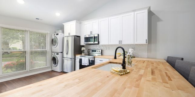 kitchen remodeling project with wood island countertop and white cabinets in Greater Lansing Michigan