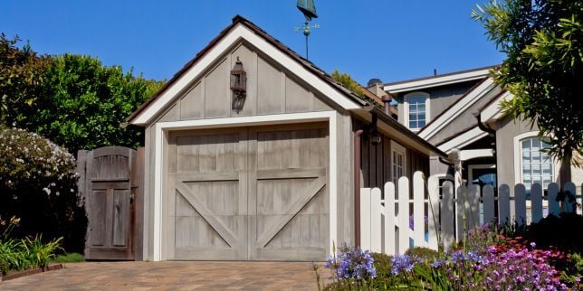 garage addition in Greater Lansing Michigan with decorative door and landscaping