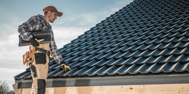 Greater Lansing roofing contractor installing new shingles