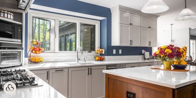 luxury kitchen remodeling project in Okemos Michigan built by Custom Built Design and Remodeling with nickel sink faucet and white cabinets