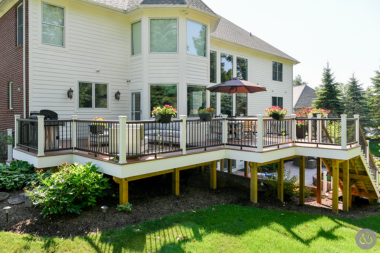 multi level composite deck with BBQ grill umbrella furniture landscaping custom built michigan