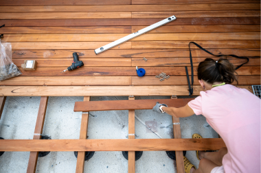 lansing homeowner building deck with wood decking boards