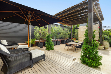 composite deck living space with outdoor furniture and pergola in Lansing Michigan