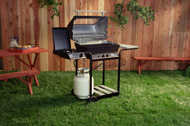 bbq grill and wood outdoor furniture in Lansing backyard