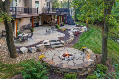 elevated composite deck with large patio area and fire pit in Lansing