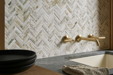 luxury kitchen remodel in Greater Lansing with gold finish faucet and herringbone tile backsplash