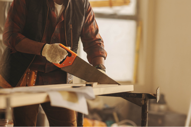 kitchen remodeler in Greater Lansing sawing wood board