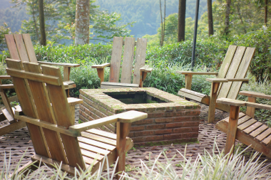 outdoor living project in Greater Lansing with brick fire pit and chairs