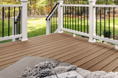 spring composite deck in Greater Lansing with white railings and black balusters