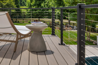 elevated composite deck with trex cable railings in Greater Lansing
