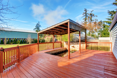 Greater Lansing deck build with wood railings and pergola