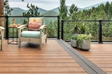 Trex glass railing on composite deck outdoor living space with outdoor furniture