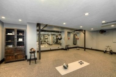 finished basement home gym with black trim and recessed lighting