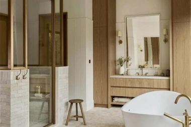 how to design a primary suite addition that feels like a retreat modern bathroom with wood accents and freestanding tub custom built michigan