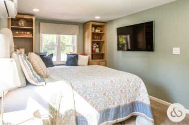 how to design a primary suite addition that feels like a retreat main bedroom with storage bench and shelving custom built michigan