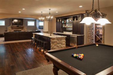 basement lighting ideas for your home remodel layered light fixtures above bar and pool table custom built michigan