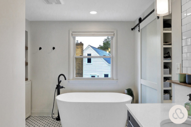 how long does a bathroom remodel take primary space with freestanding bathtub and barn door custom built michigan