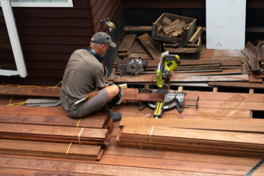 ways demolition impacts deck replacement costs builder installing hardwood decking boards custom built michigan