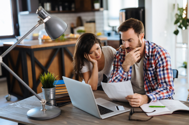 problems with working within allowances during your home remodel married couple reviewing remodeling budget custom built michigan