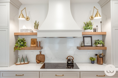 how to plan your kitchen renovation costs around your long term home goals induction range with decorative hood and floating shelves custom built michigan