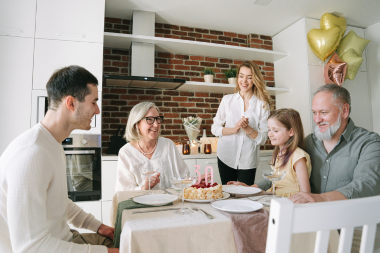 how to plan your kitchen renovation costs around your long term home goals family gathered at dinner table custom built michigan