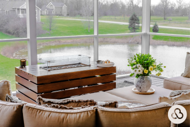 best qualities to look for in a home addition builder covered deck with fire table and large windows custom built michigan